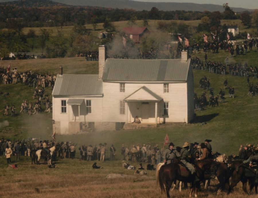 A wide view of the Heater House with a lot of soldiers and several horses